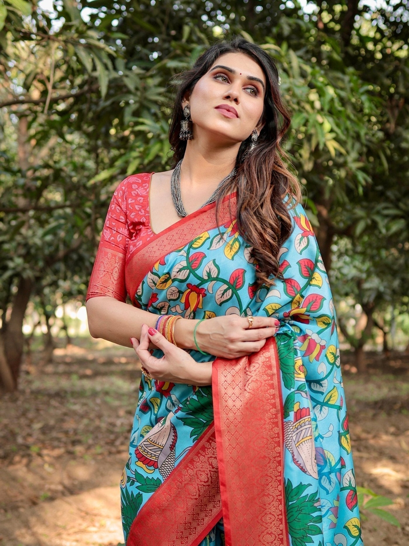 Aqua Blue Tussar Silk Saree with Vibrant Nature-Inspired Prints and Red Zari Border