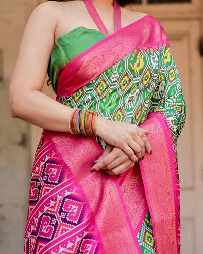 Green and Pink Tussar Silk Saree with Vibrant Ikat Patterns and Zari Border